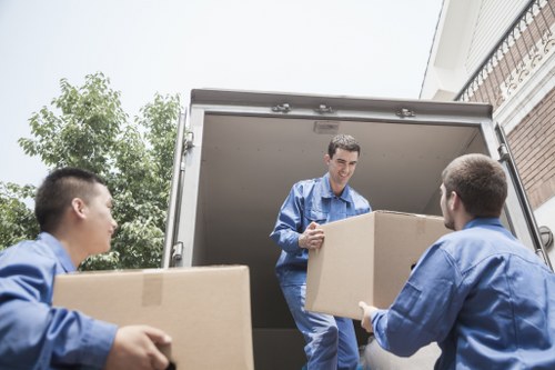 Professional movers assisting with packing in Marks Gate